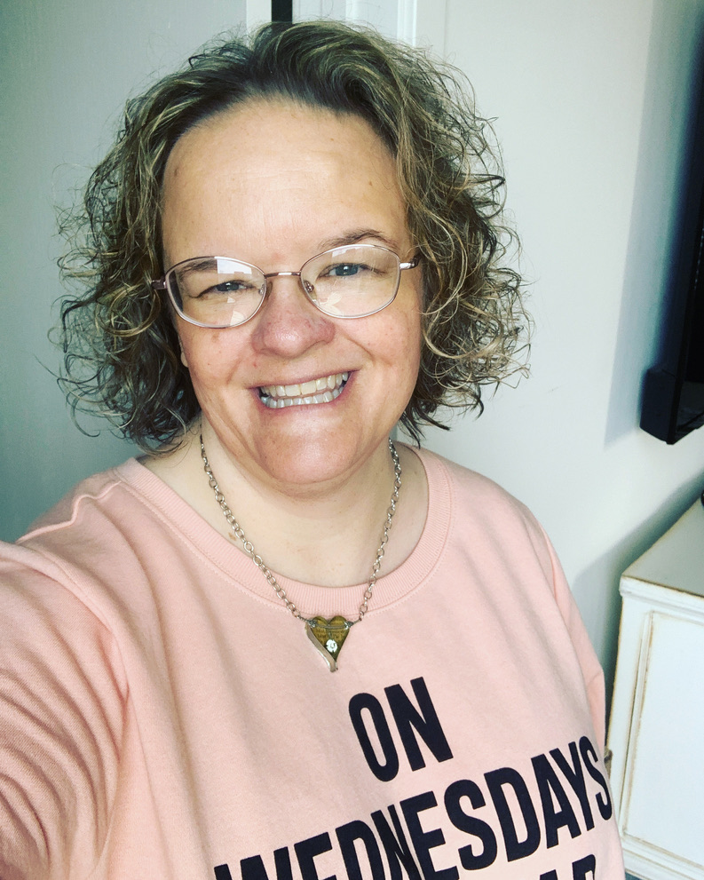 Melissa, wearing her "On Wednesdays we wear Pink" sweatshirt and beaming at you!